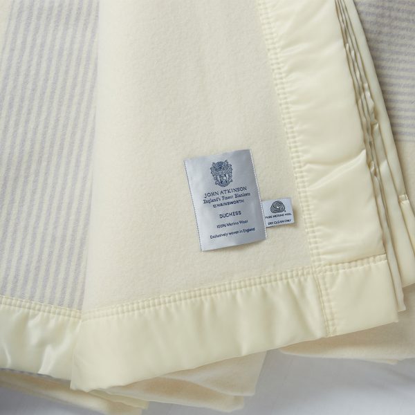 the cool grey stripe duchess blanket hanging, with the John Atkinson label proudly showing